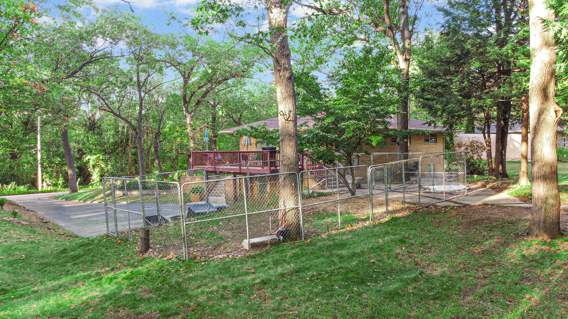 5001 Marquette Road Lake Station, IN 46405 - Photo 23 of 32 a view of a backyard with a slide trees and wooden fence