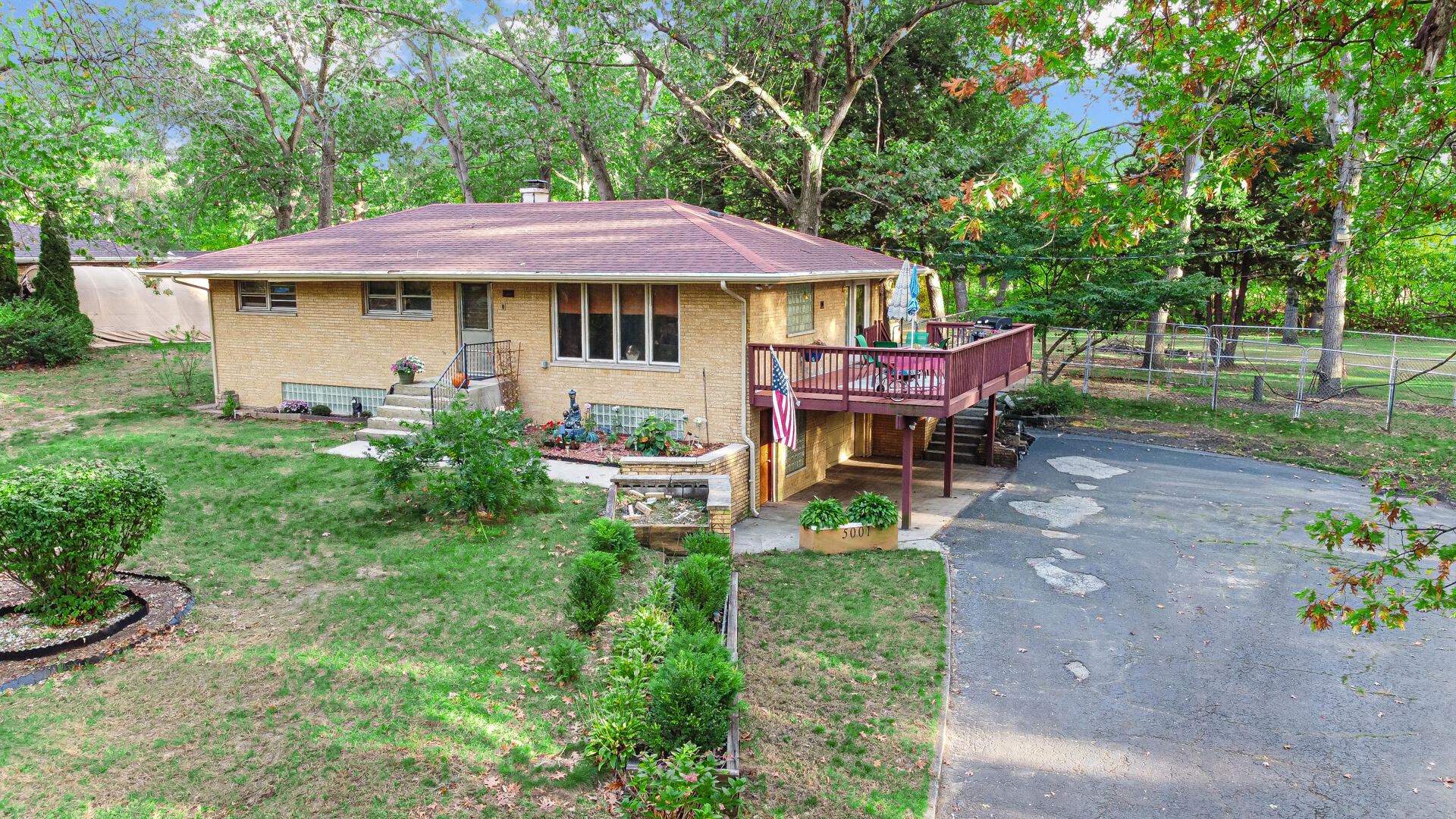 5001 Marquette Road Lake Station, IN 46405 - Photo 27 of 32 a view of a patio with table and chairs under an umbrella