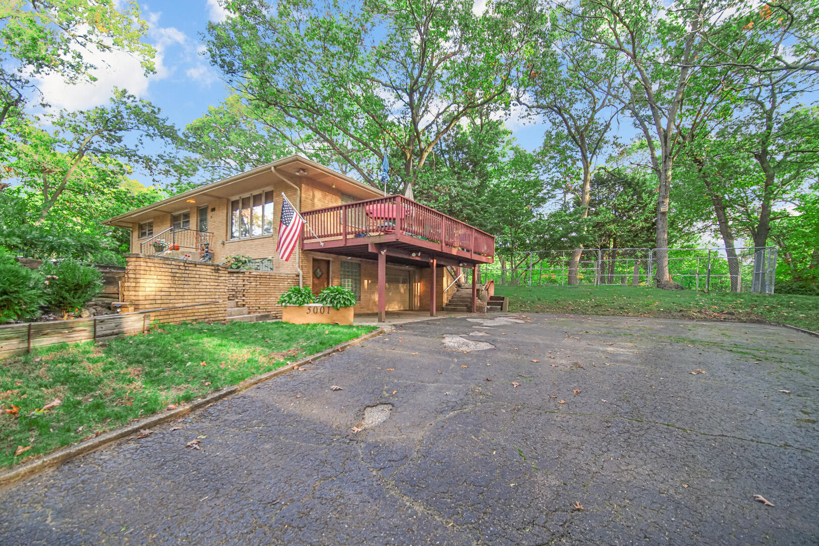 5001 Marquette Road Lake Station, IN 46405 - Photo 3 of 32 a view of a house with a yard and large trees
