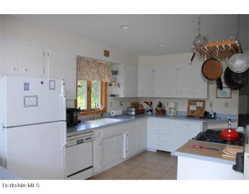 95 N Road Monroe, MA 01350 - Photo 13 of 22 a kitchen with granite countertop a sink a stove and cabinets