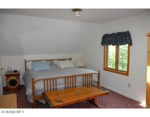 95 N Road Monroe, MA 01350 - Photo 17 of 22 a bedroom with a bed window and a table in it