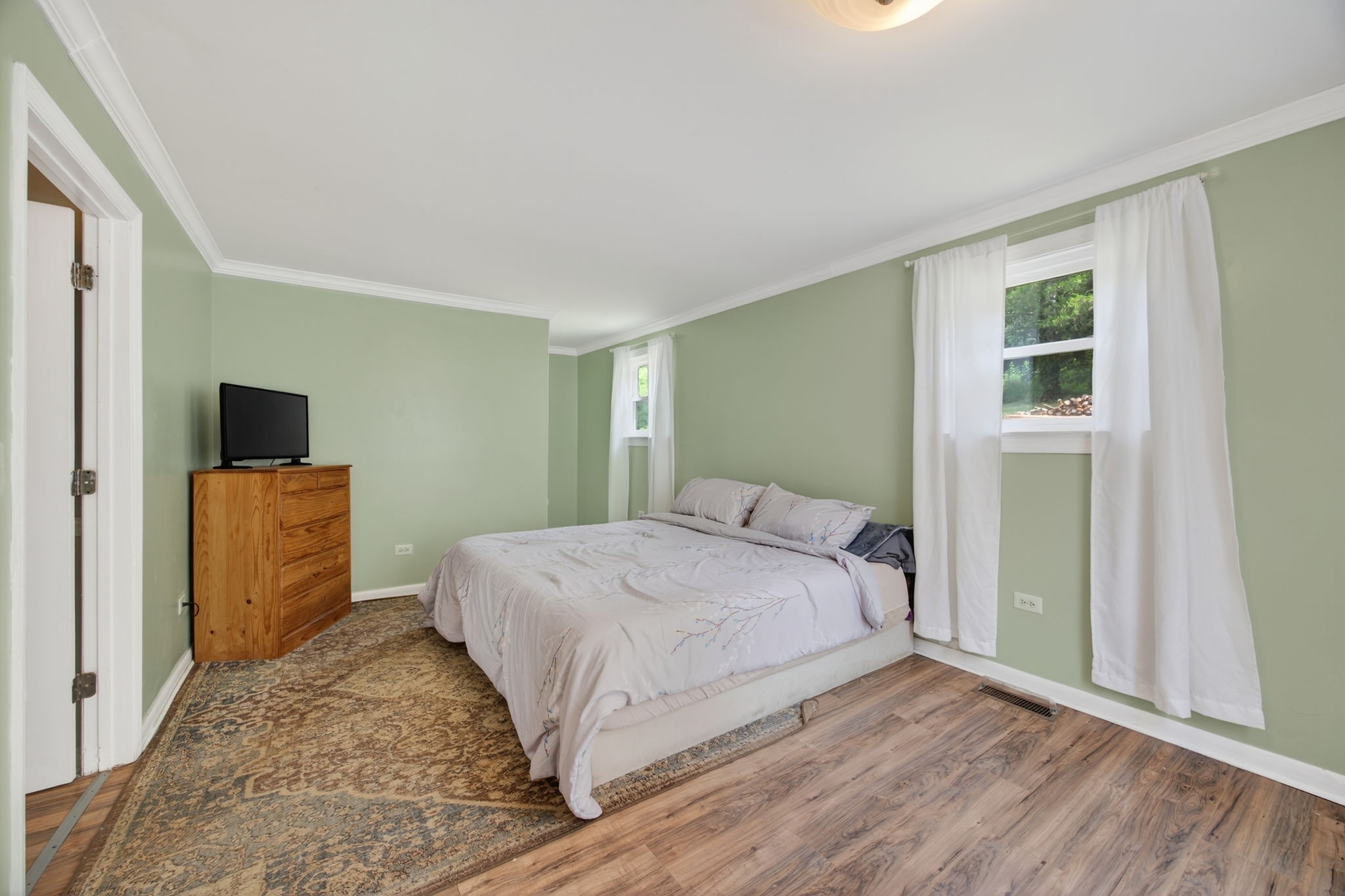 3203 Statesville Road Watertown, TN 37184 - Photo 21 of 56 a bedroom with a large bed and a flat tv screen on dresser