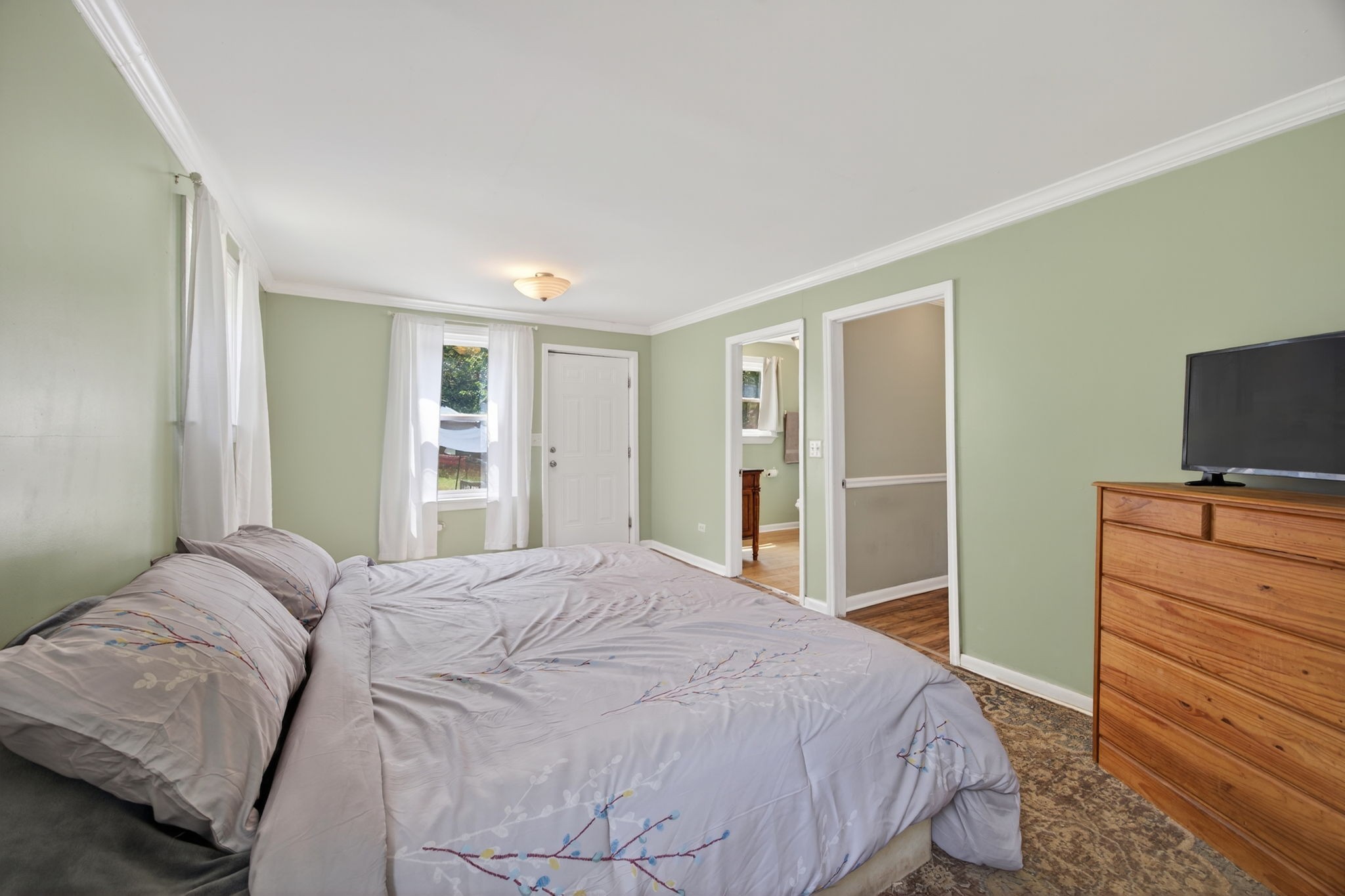 3203 Statesville Road Watertown, TN 37184 - Photo 22 of 56 a bedroom with a large bed and a flat tv screen on a dresser