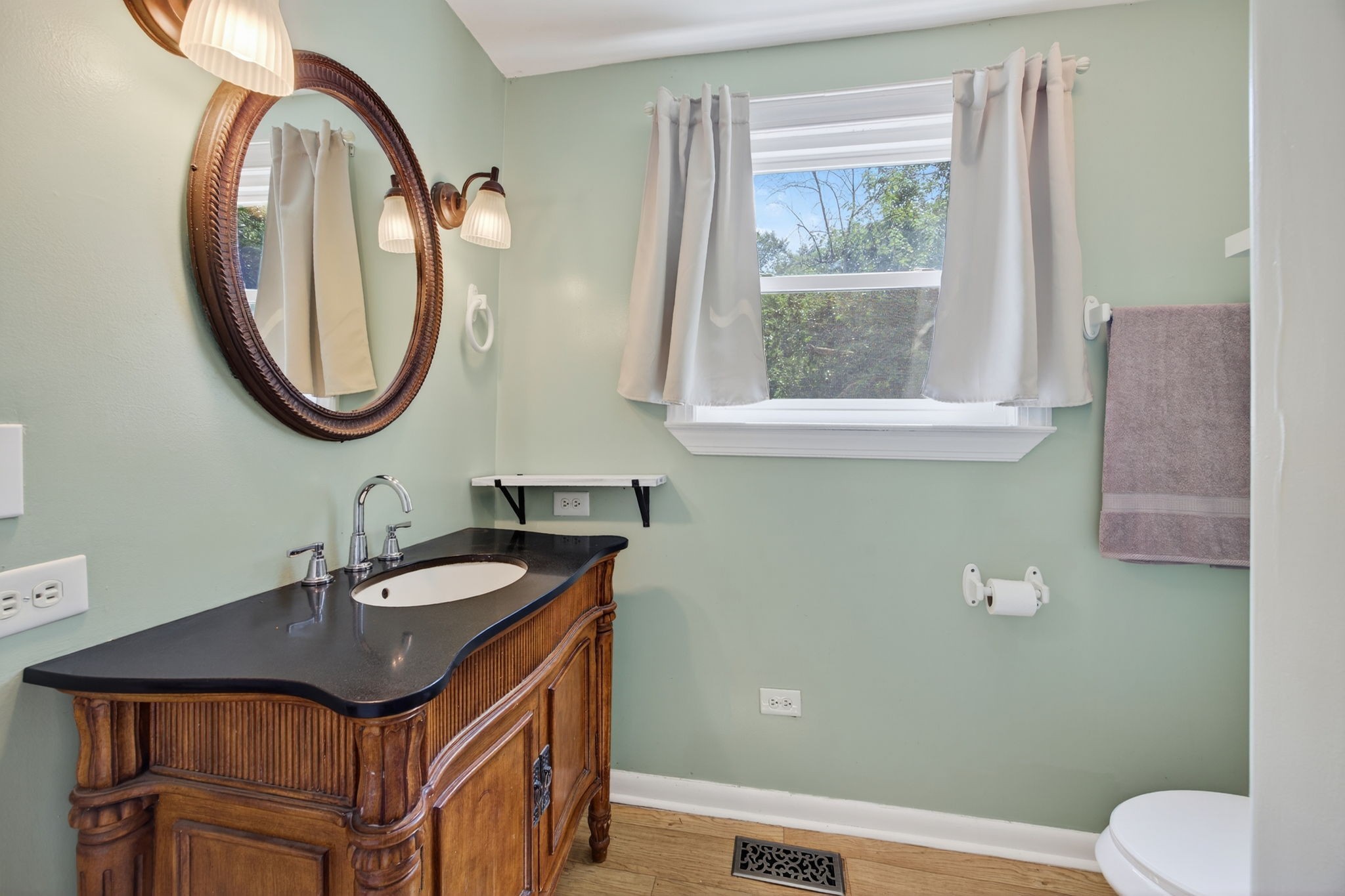 3203 Statesville Road Watertown, TN 37184 - Photo 24 of 56 a bathroom with a granite countertop toilet sink and mirror