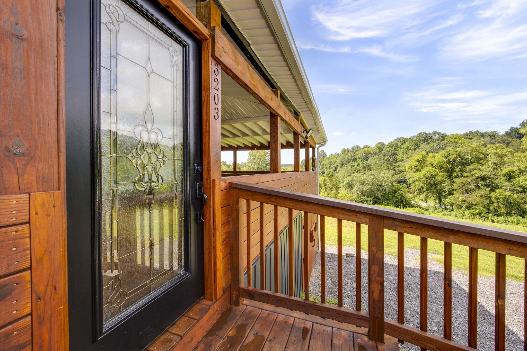 3203 Statesville Road Watertown, TN 37184 - Photo 7 of 56 a view of balcony with floor to ceiling window and wooden floor