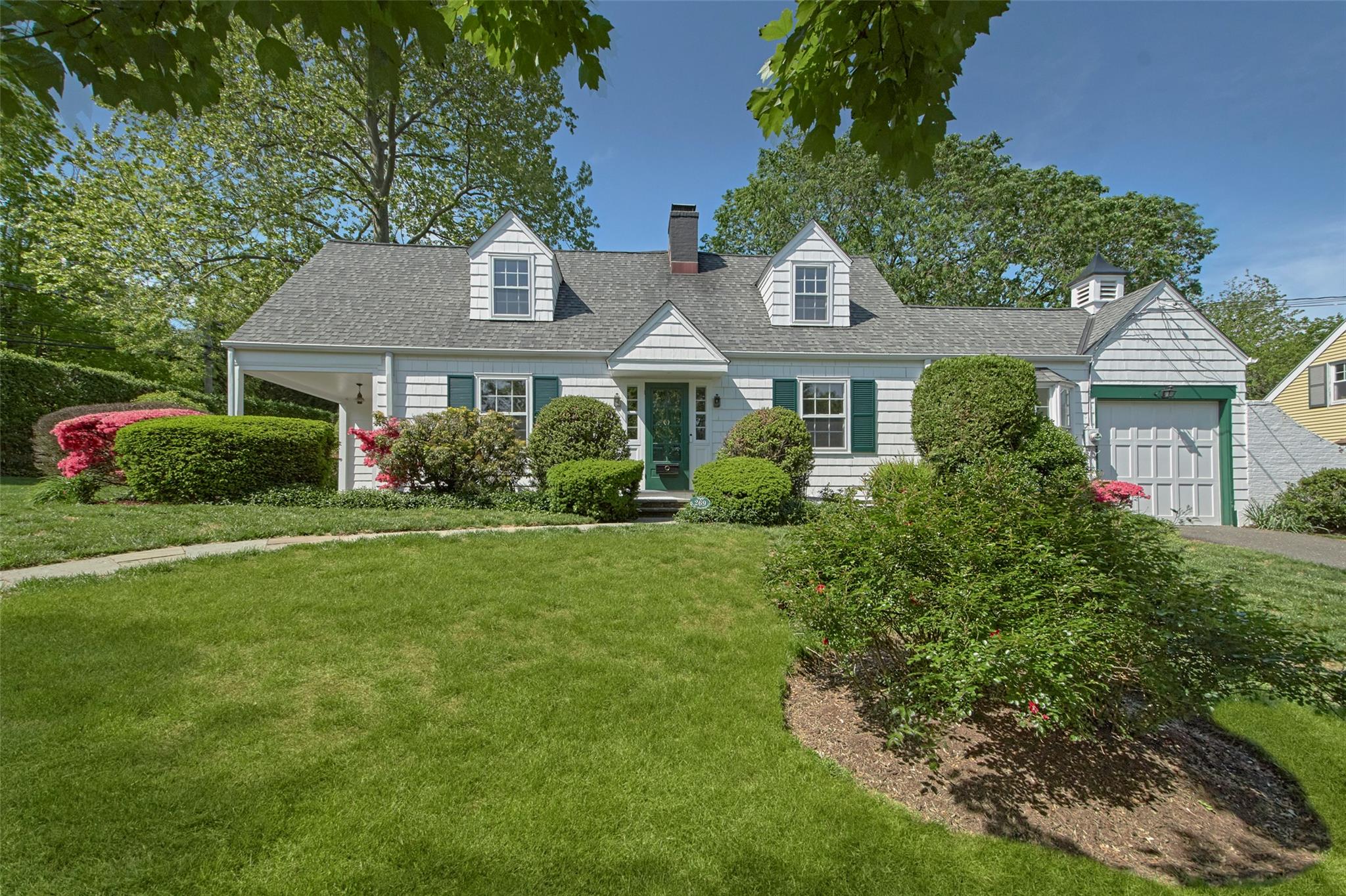 269 Betsy Brown Road Rye Brook, NY 10573 - Photo 1 of 1 a front view of a house with garden
