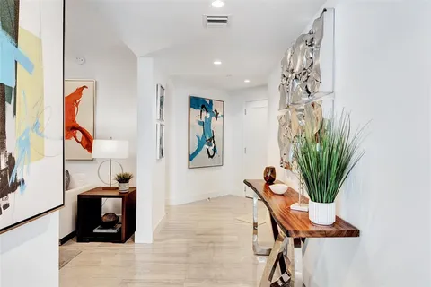 a bedroom with a bed and painting on the wall