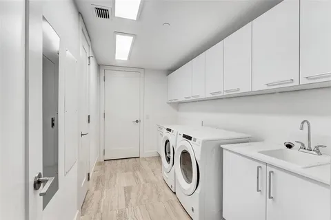 a bathroom with a granite countertop bathtub sink vanity mirror and toilet