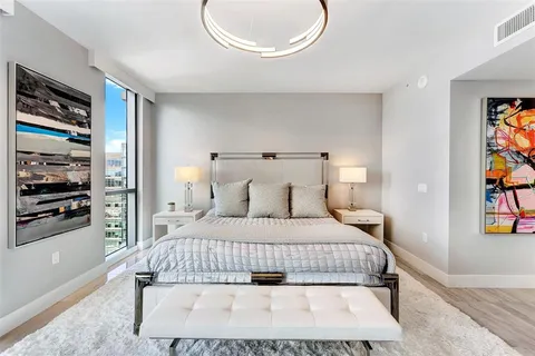 a bedroom with a bed and a chandelier