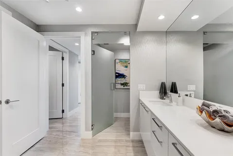 a view of a hallway with wooden floor and a potted plant
