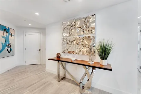 a living room with furniture and a view of kitchen