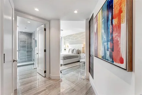 a living room with furniture kitchen view and a large window