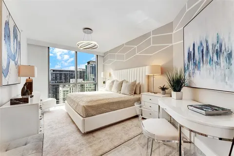 a lobby with furniture and a potted plant