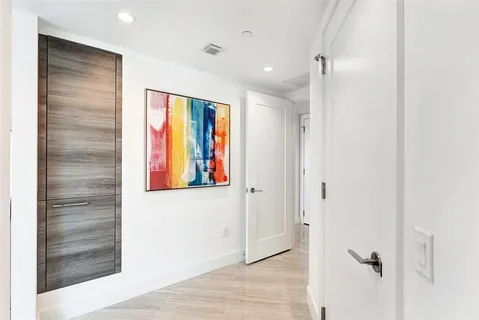 a kitchen with stainless steel appliances kitchen island granite countertop a table chairs and a view of living room