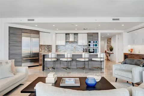 a living room with patio furniture and a large window