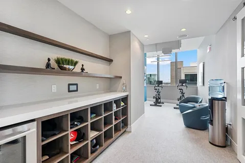 a large white kitchen with a large window