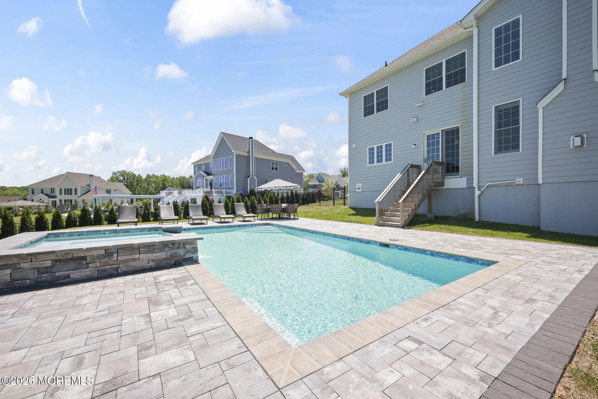 66 Windermere Road Lincroft, NJ 07738 - Photo 35 of 48 a view of a swimming pool with a lounge chairs