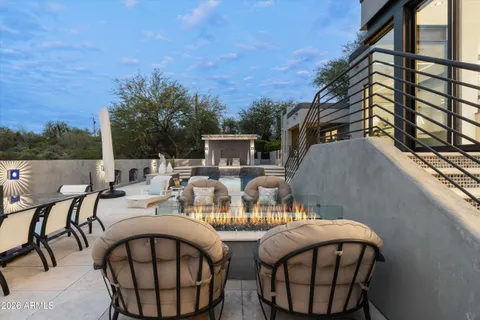 a roof deck with table and chairs