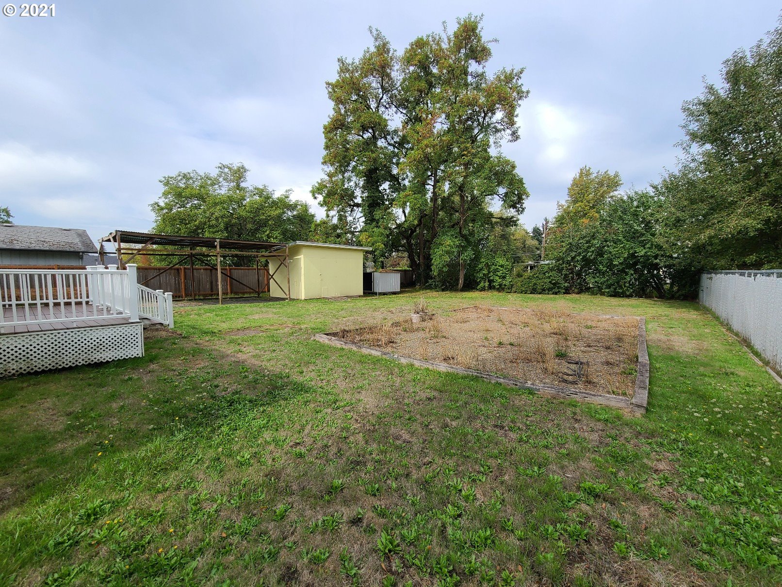 5158 D Street Springfield, OR 97478 - Photo 14 of 14 a backyard of a house with lots of green space and plants
