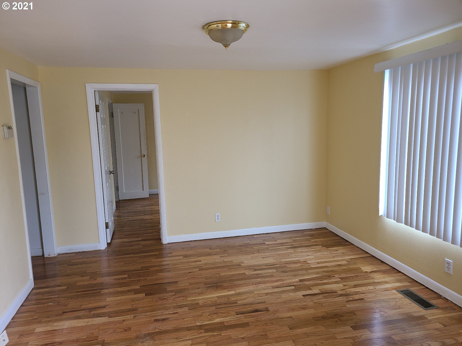 5158 D Street Springfield, OR 97478 - Photo 5 of 14 a view of an empty room with wooden floor and a window