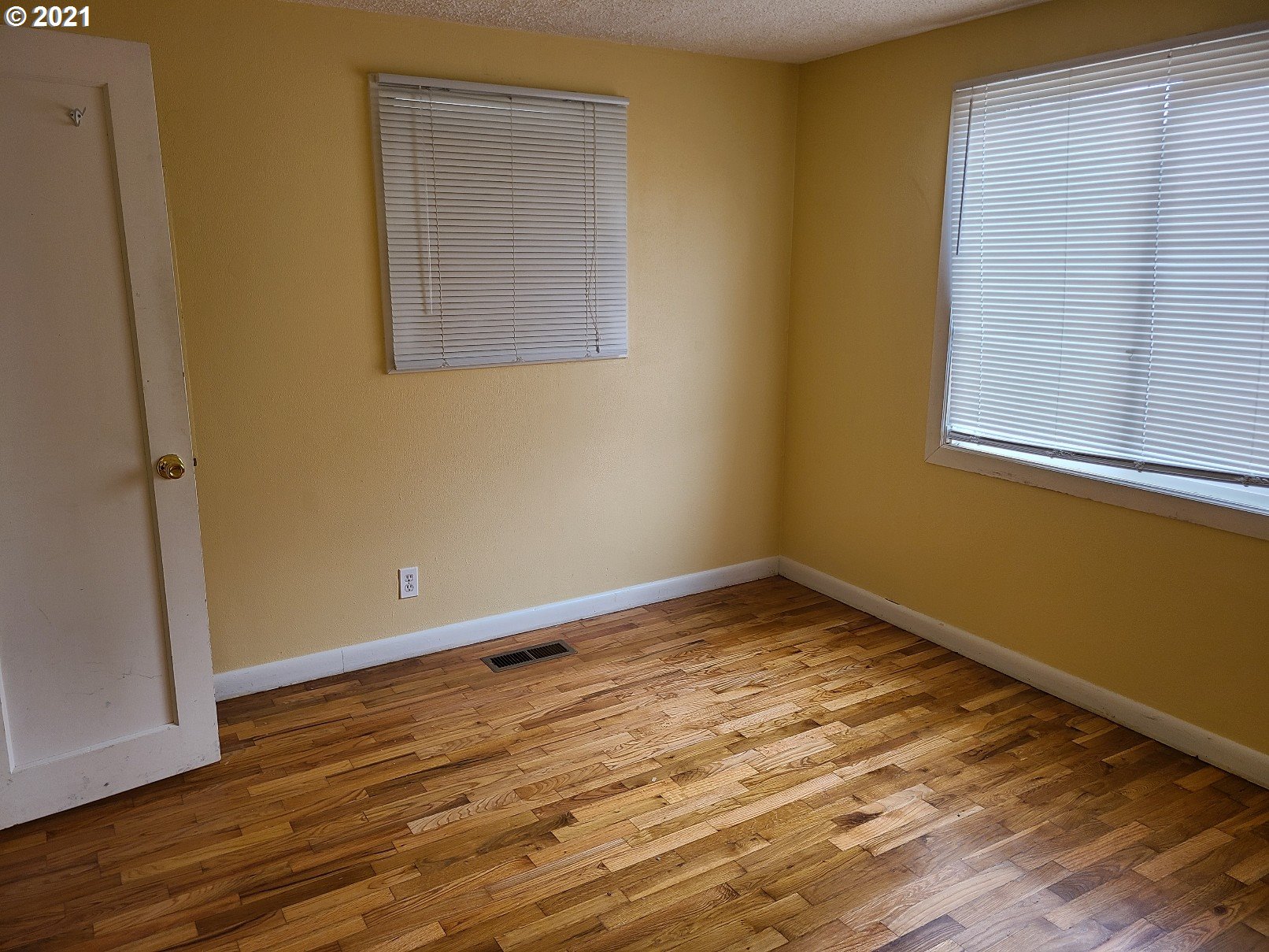 5158 D Street Springfield, OR 97478 - Photo 6 of 14 an empty room with wooden floor and windows