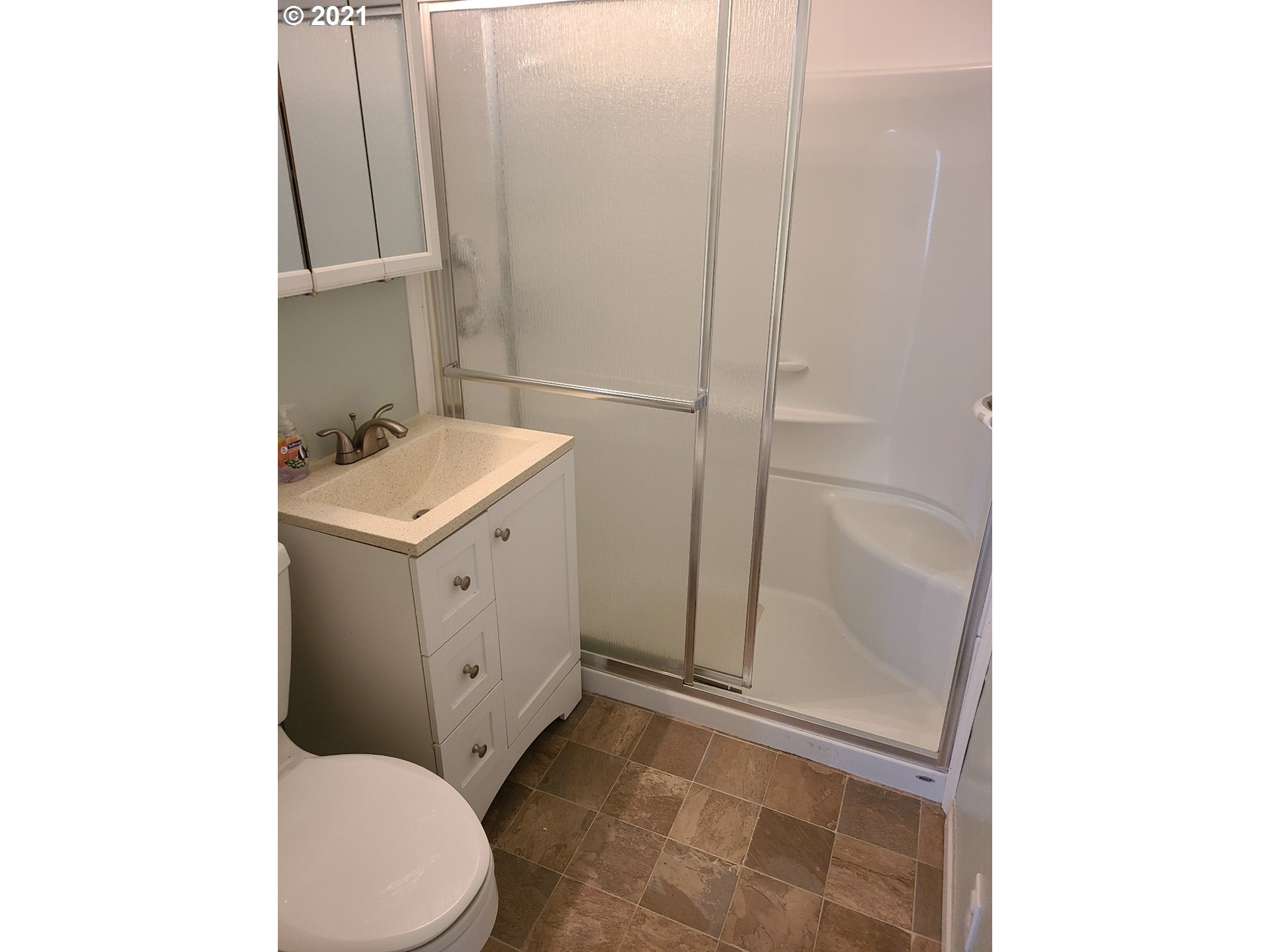 5158 D Street Springfield, OR 97478 - Photo 7 of 14 a bathroom with a sink a toilet and shower