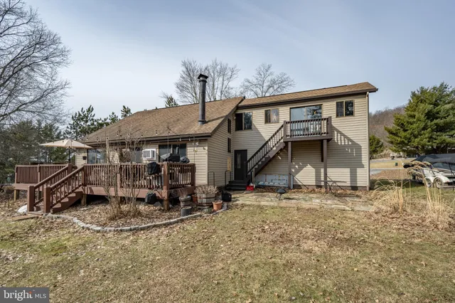 a view of balcony with furniture and umbrella