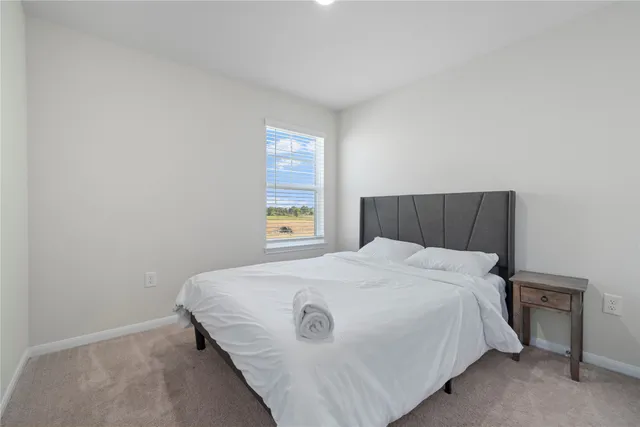 a bedroom with a bed and window