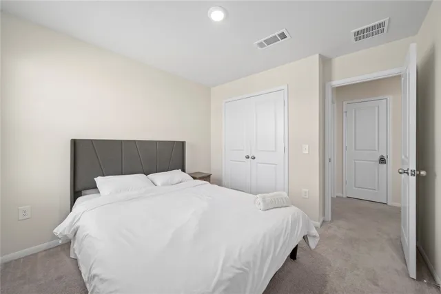 a bedroom with a bed and a night stand