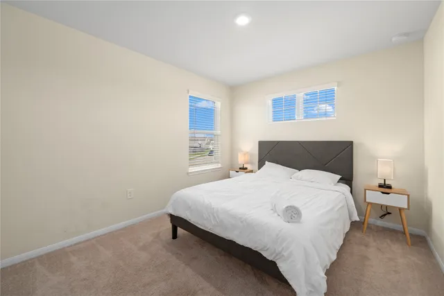 a bedroom with a bed and a night stand