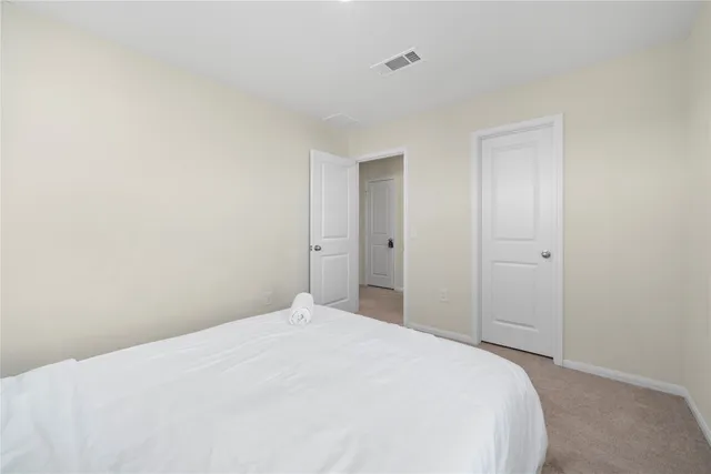 a bedroom with a bed and a bathroom