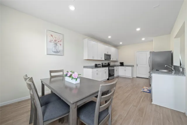 a view of a dining room with furniture and wooden floor