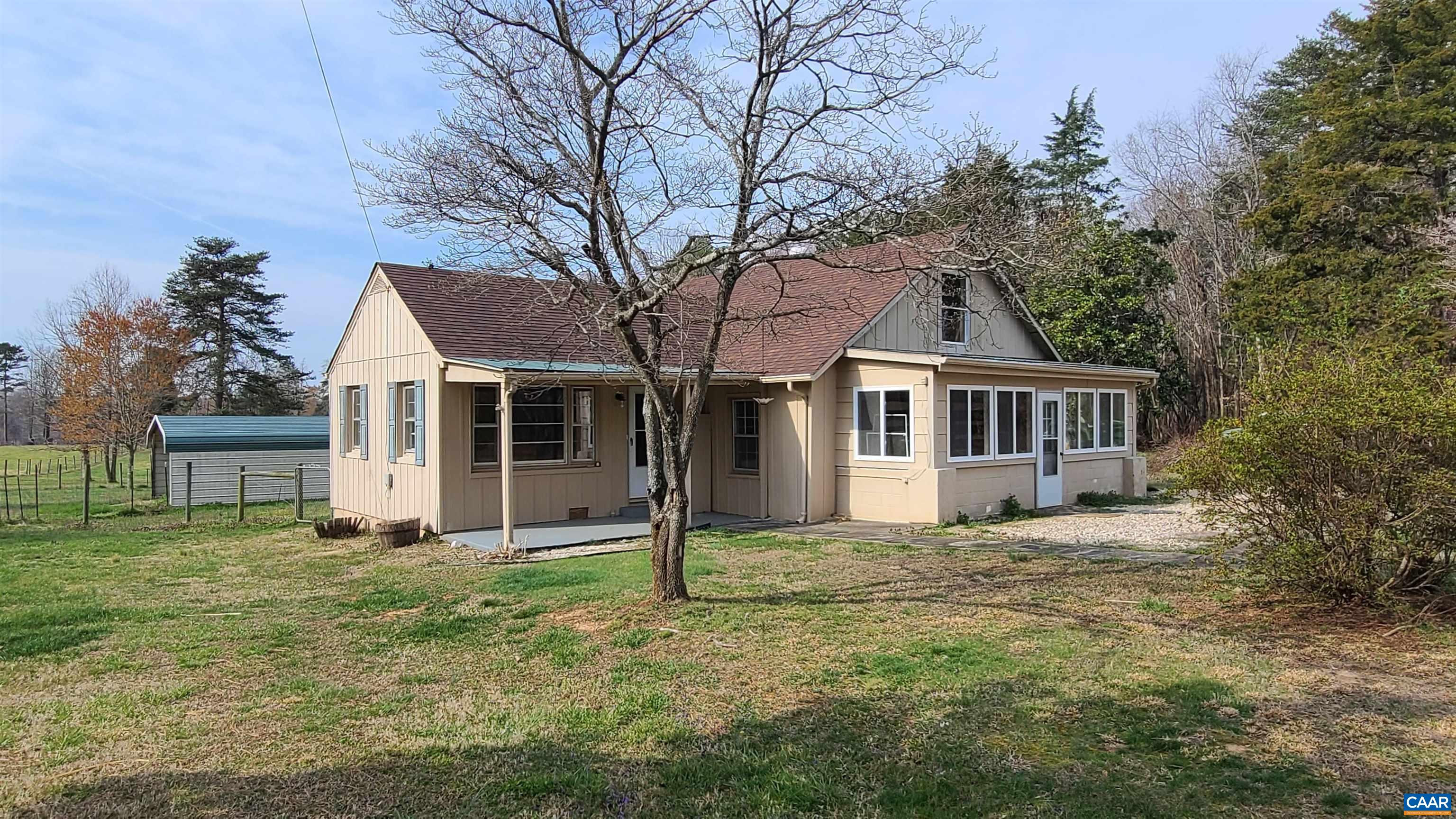 a house that has a tree in front of the house