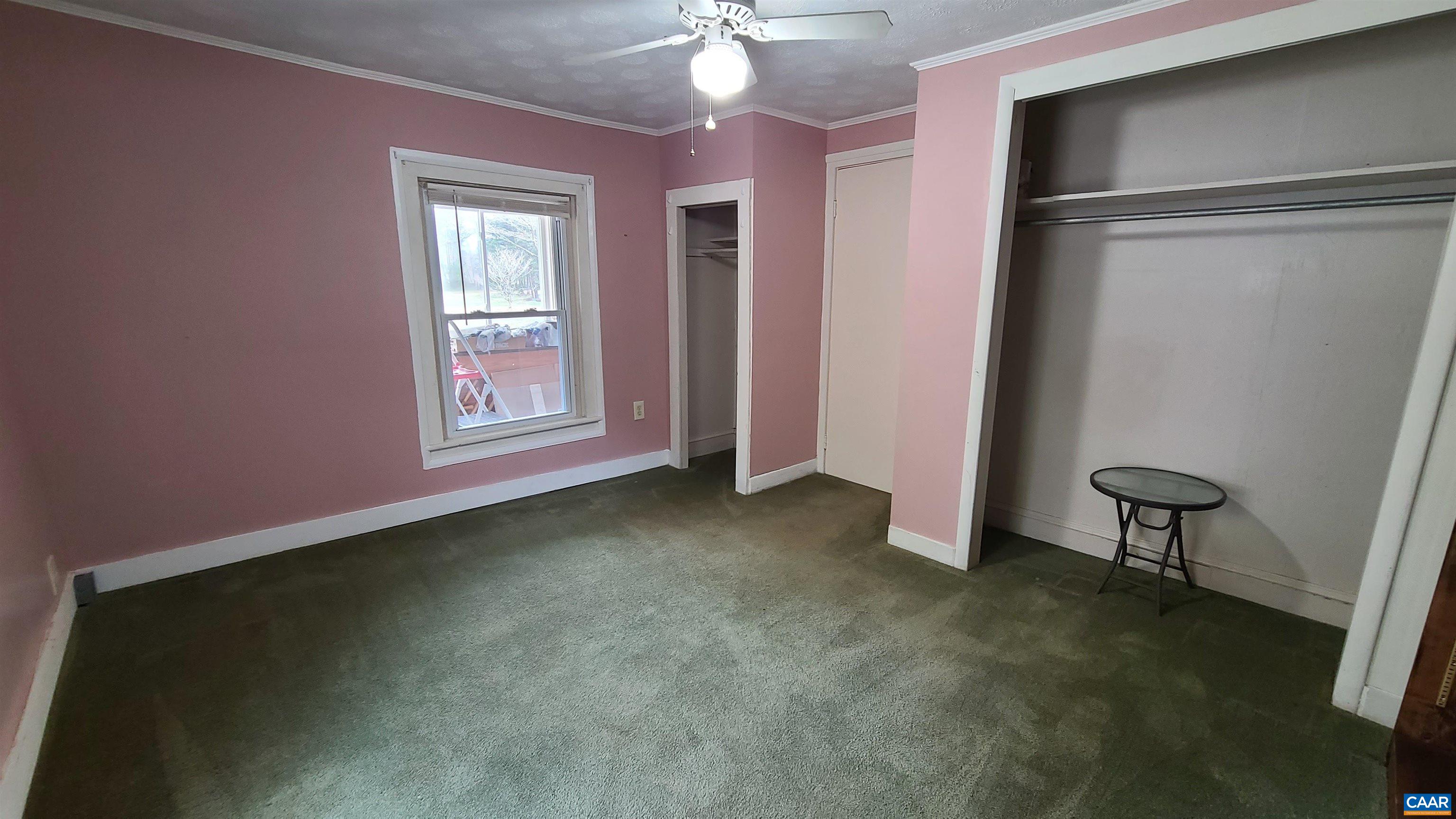 240 Lee Wayside Road Buckingham, VA 23921 - Photo 14 of 42 an empty room with windows and fan