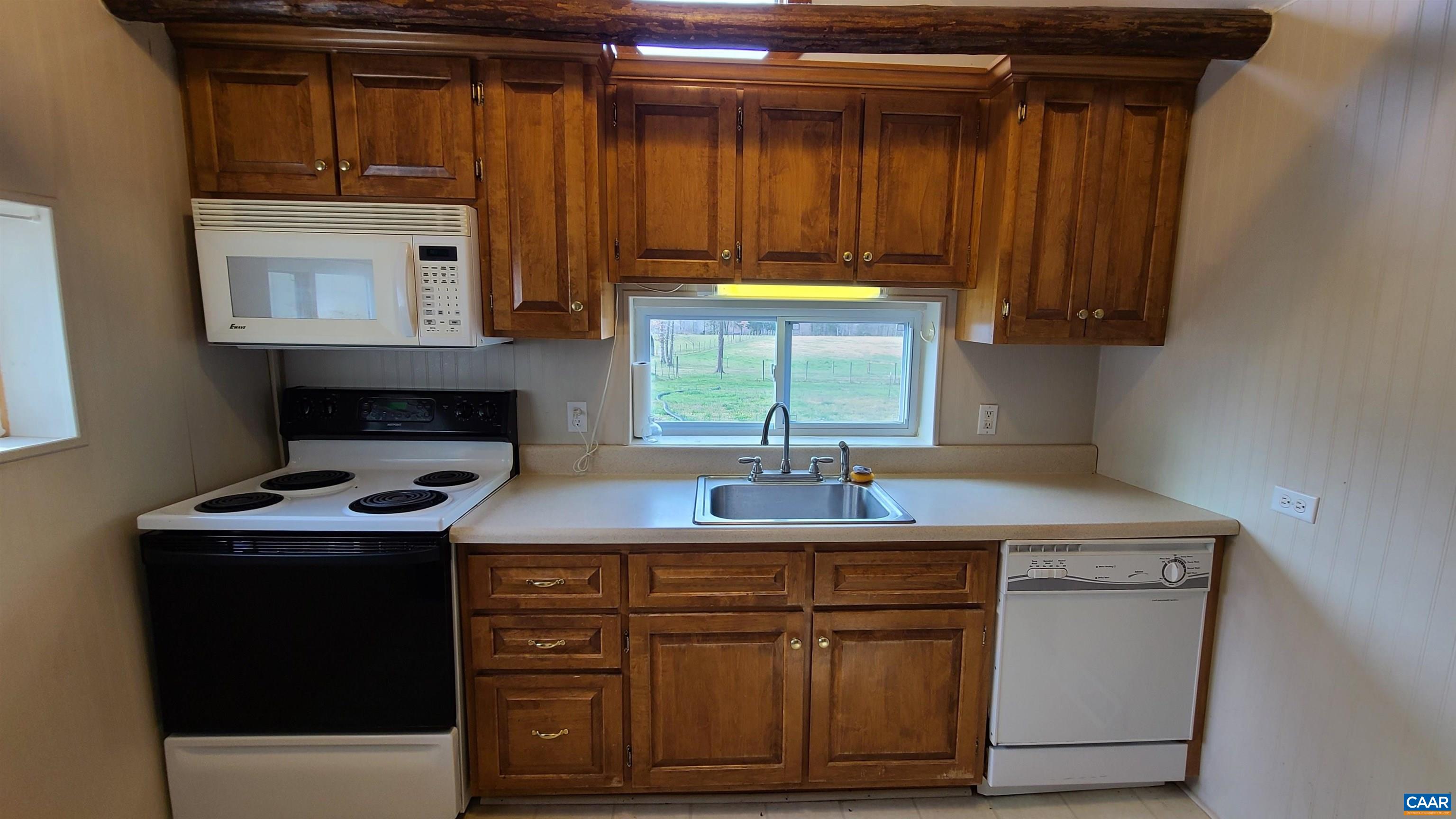 240 Lee Wayside Road Buckingham, VA 23921 - Photo 9 of 42 a kitchen with kitchen island granite countertop a sink stove and cabinets