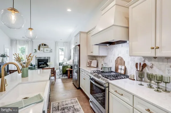 a kitchen with stove a sink and cabinets