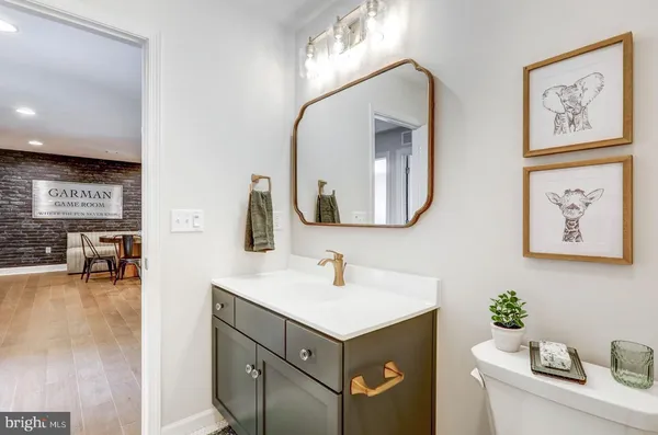 a bathroom with a sink vanity and a mirror