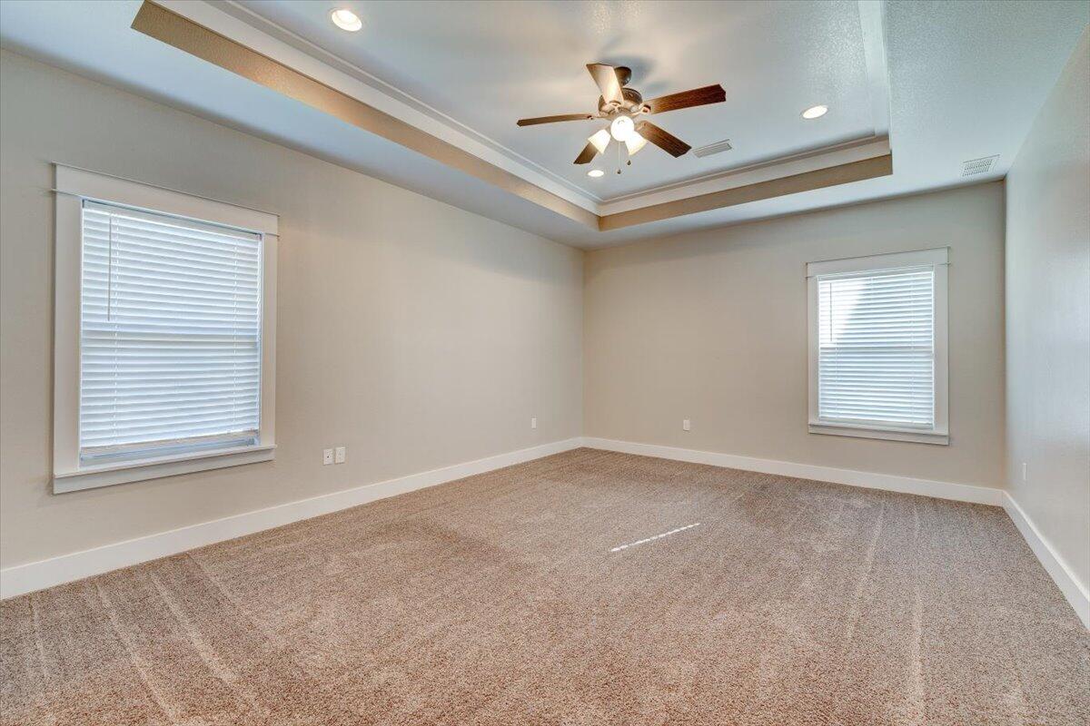 3956 Painter Branch Road Crestview, FL 32539 - Photo 11 of 28 an empty room with windows and ceiling fan