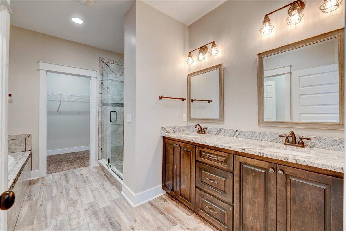 3956 Painter Branch Road Crestview, FL 32539 - Photo 12 of 28 a bathroom with a double vanity sink a mirror and a shower