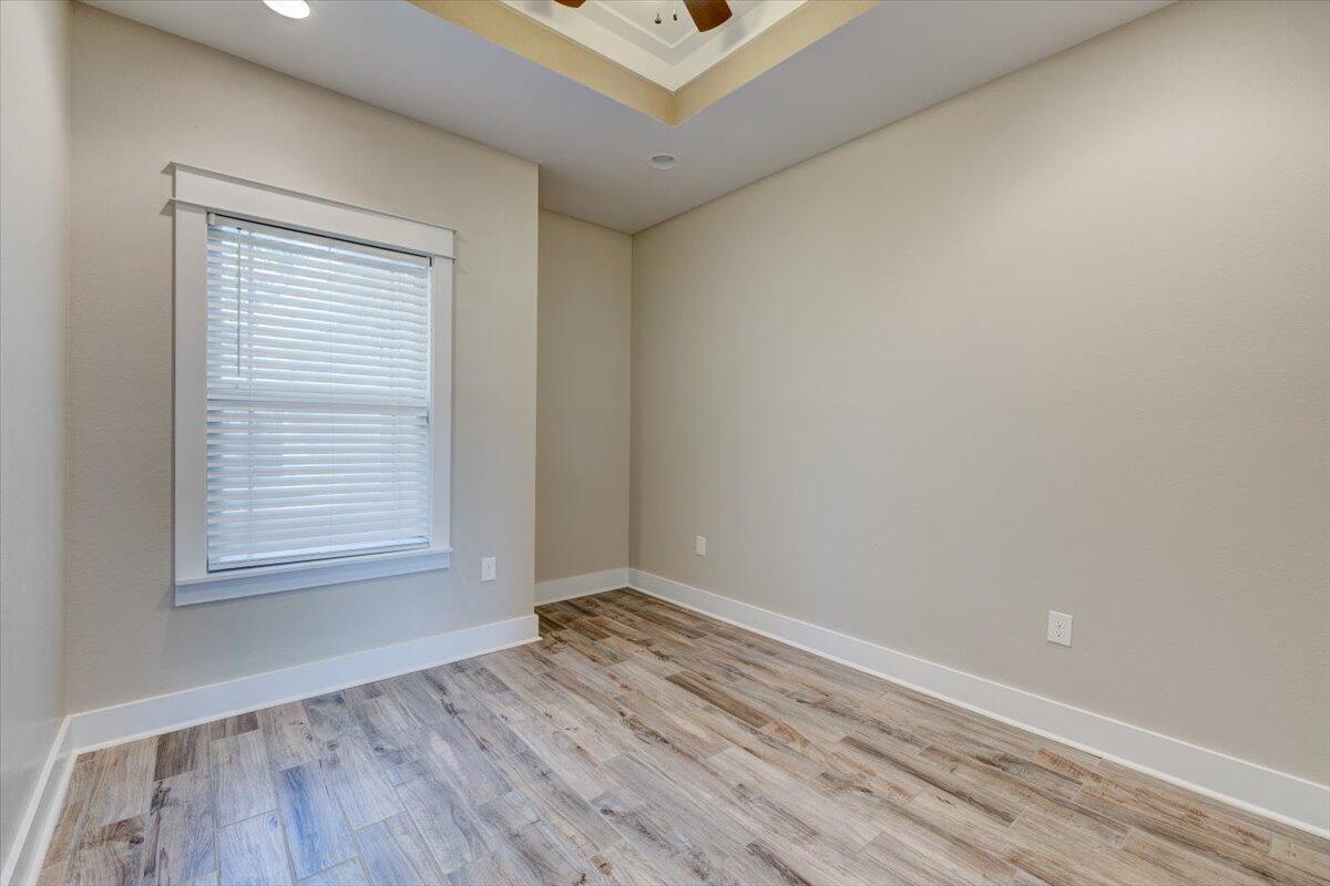 3956 Painter Branch Road Crestview, FL 32539 - Photo 20 of 28 an empty room with wooden floor and windows