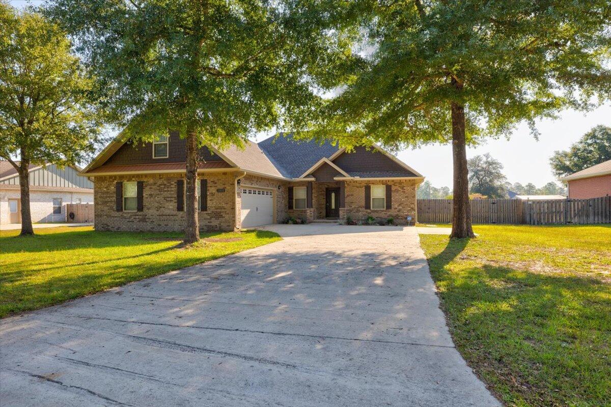 3956 Painter Branch Road Crestview, FL 32539 - Photo 2 of 28 a house with swimming pool in front of it