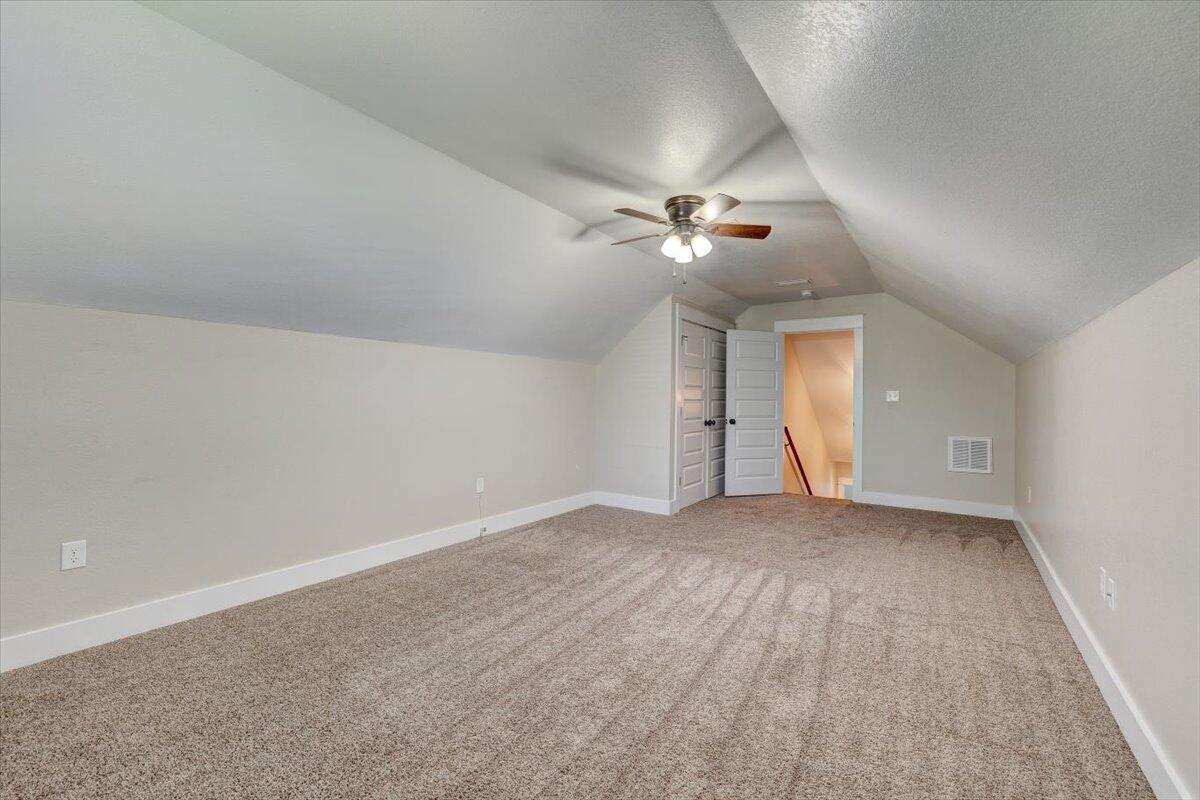 3956 Painter Branch Road Crestview, FL 32539 - Photo 24 of 28 wooden floor in an empty room with a chandelier fan