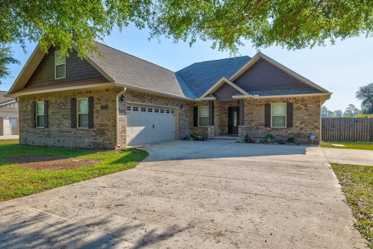 3956 Painter Branch Road Crestview, FL 32539 - Photo 3 of 28 a front view of a house with a yard and garage