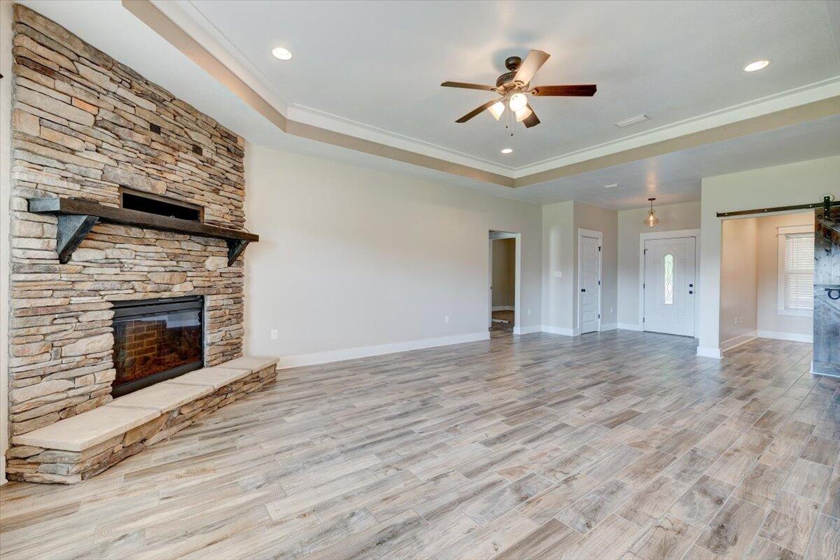 3956 Painter Branch Road Crestview, FL 32539 - Photo 6 of 28 a view of an empty room with a fireplace and a ceiling fan