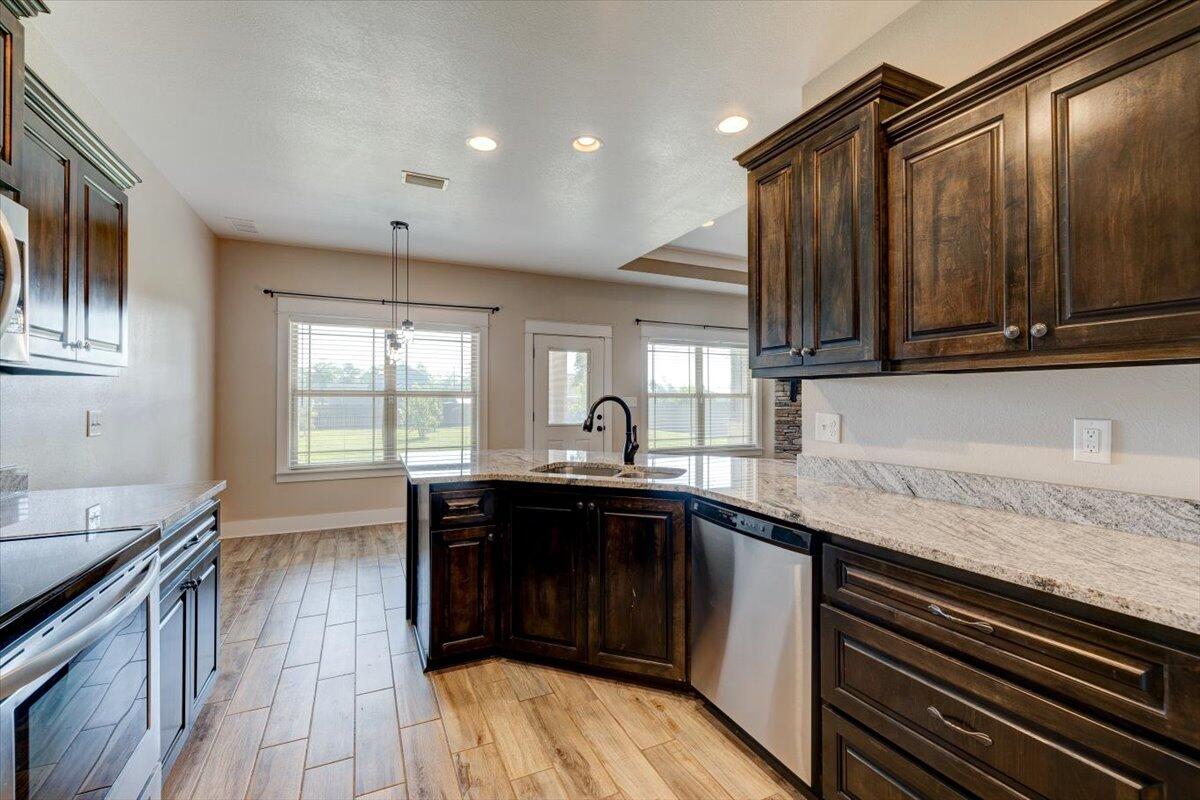 3956 Painter Branch Road Crestview, FL 32539 - Photo 10 of 28 a kitchen with a sink stove and cabinets