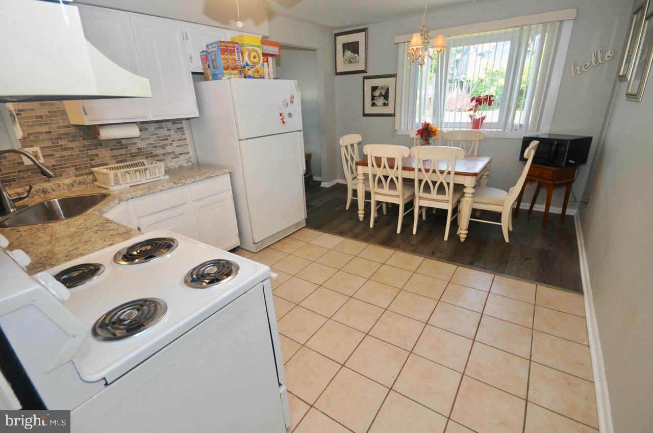 710 Blue Bell Road Williamstown, NJ 08094 - Photo 12 of 19 a kitchen with a stove a refrigerator and a dining table