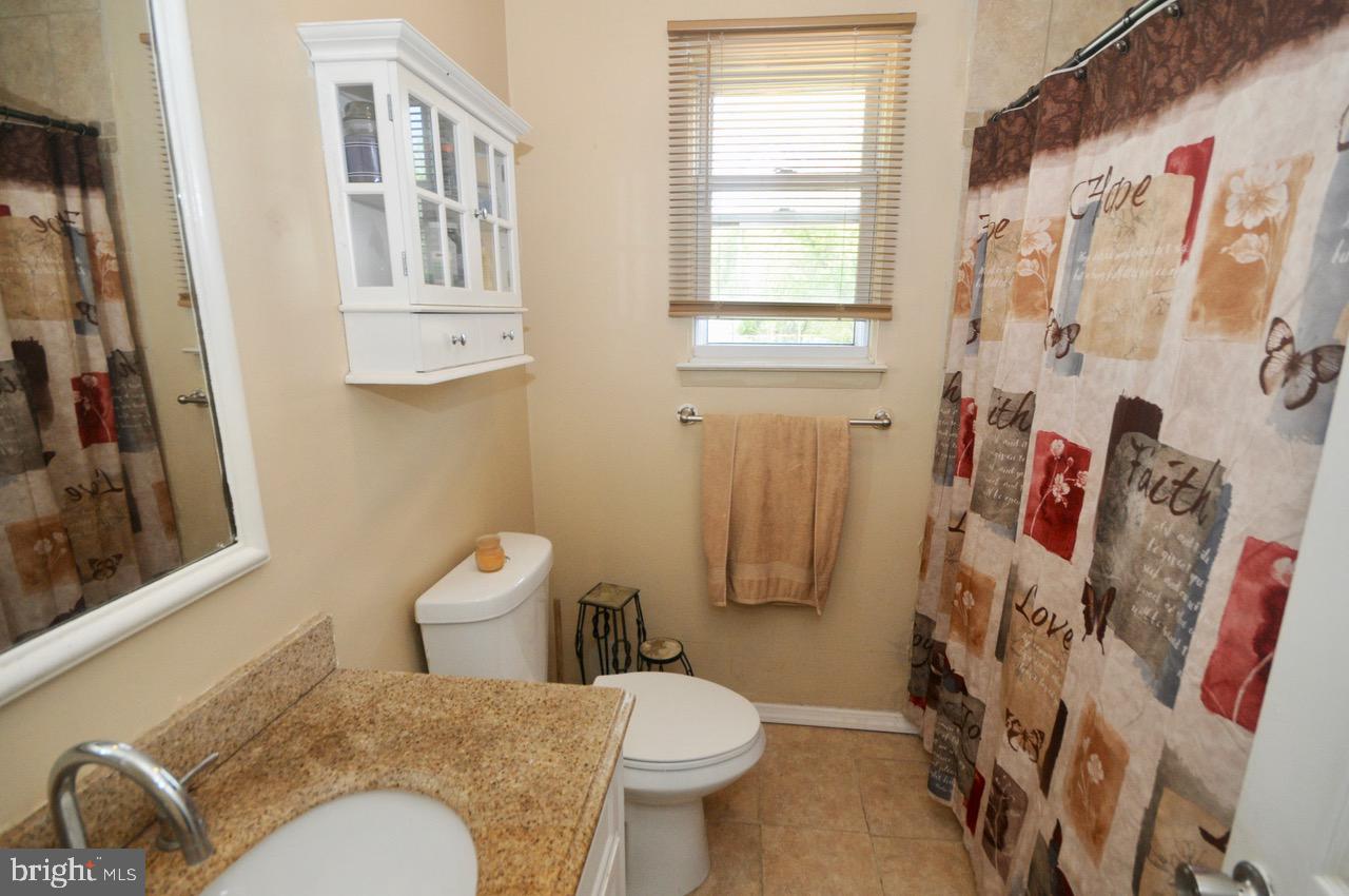 710 Blue Bell Road Williamstown, NJ 08094 - Photo 4 of 19 a white toilet sitting next to a bathroom sink and tub