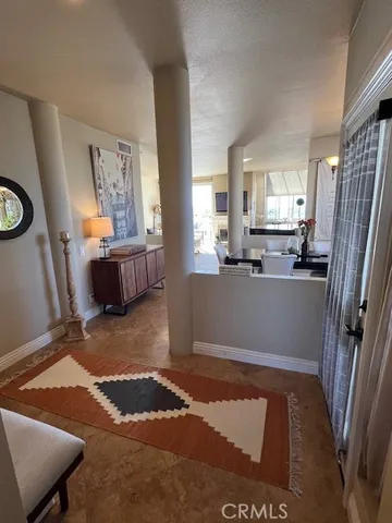 a view of kitchen with furniture and refrigerator
