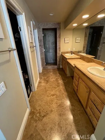 a bathroom with sink shower and mirror