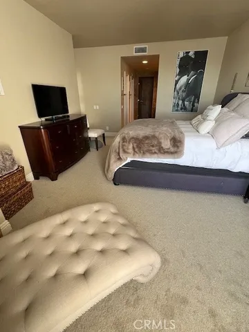 a bedroom with a bed and flat screen tv
